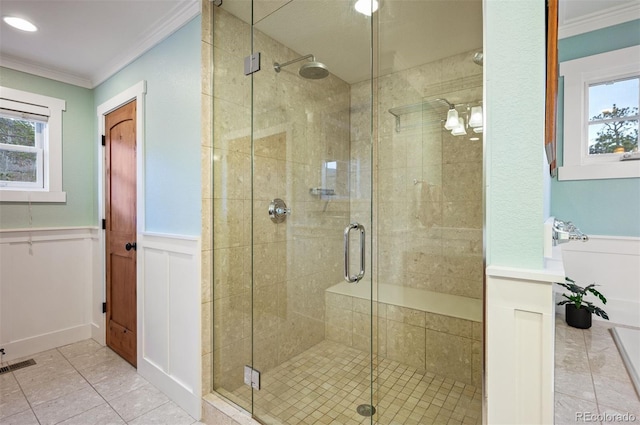 1055 Divide View Dr, Golden, CO 80403 - bathroom featuring crown molding, tile patterned floors, a wealth of natural light, and a shower stall