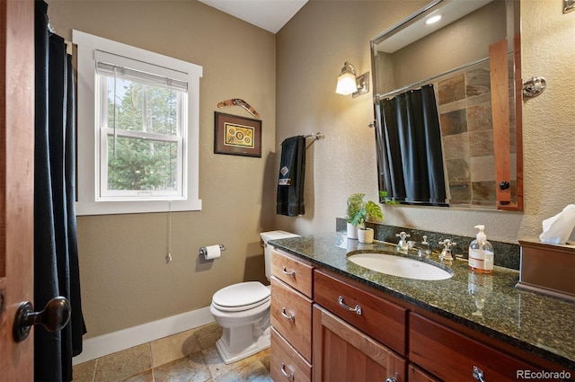 1055 Divide View Dr, Golden, CO 80403 - full bath with vanity, toilet, a shower with shower curtain, baseboards, and stone finish flooring