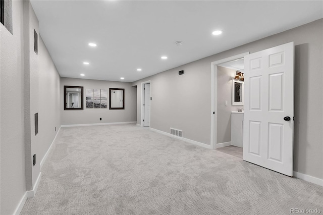 interior space with recessed lighting, visible vents, light colored carpet, and baseboards