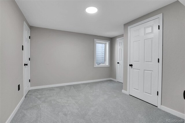 unfurnished bedroom with baseboards and carpet floors