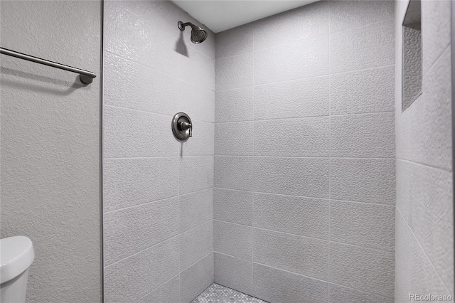 bathroom with a tile shower