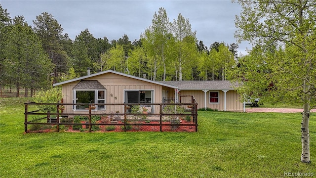 1451 Black Foot Trl, Woodland Park, CO 80863 - ranch-style house featuring a front yard and a wooded view