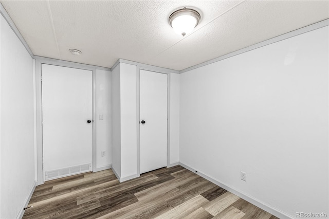 120 Pinon Dr, Hotchkiss, CO 81419 - unfurnished bedroom featuring wood finished floors, a textured ceiling, and a closet