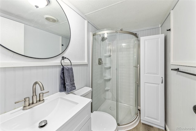 120 Pinon Dr, Hotchkiss, CO 81419 - full bathroom with a stall shower, vanity, wood finished floors, and a textured ceiling