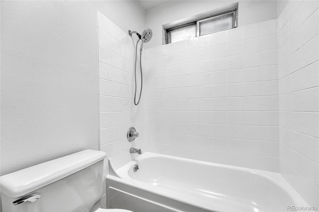 full bathroom with toilet, a textured wall, and washtub / shower combination
