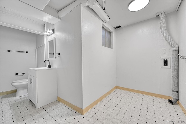 bathroom featuring toilet, tile patterned floors, baseboards, and vanity