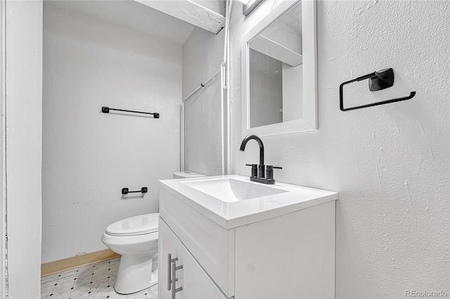 bathroom featuring toilet, tile patterned floors, and vanity