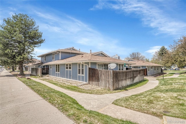 exterior space featuring a lawn and fence