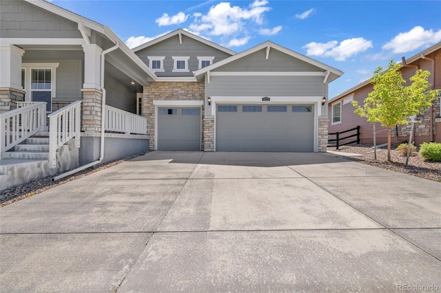 8772 S Sicily Ct, Aurora, CO 80016 - view of front of property with stone siding, concrete driveway, an attached garage, and a porch