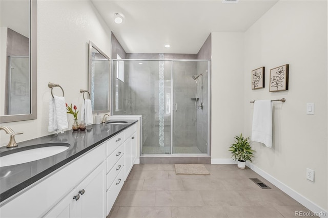 8772 S Sicily Ct, Aurora, CO 80016 - bathroom with double vanity, a shower stall, and tile patterned floors