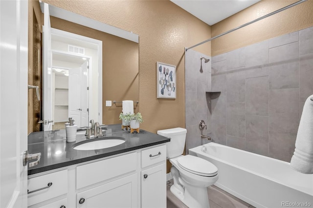 8772 S Sicily Ct, Aurora, CO 80016 - bathroom featuring vanity, bathtub / shower combination, and a textured wall