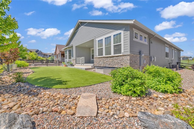 8772 S Sicily Ct, Aurora, CO 80016 - back of house featuring stone siding