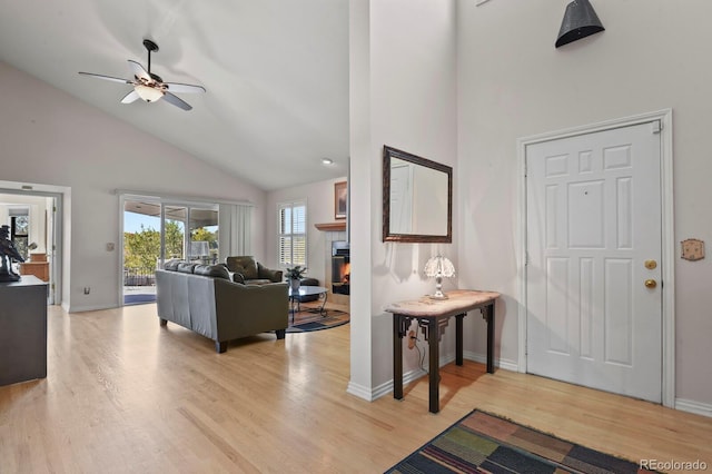 entrance foyer with light wood-type flooring, high vaulted ceiling, and ceiling fan