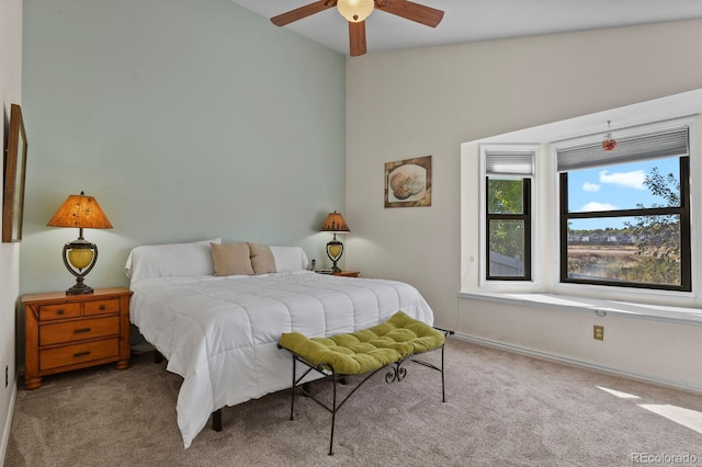 bedroom with ceiling fan, light colored carpet, and lofted ceiling