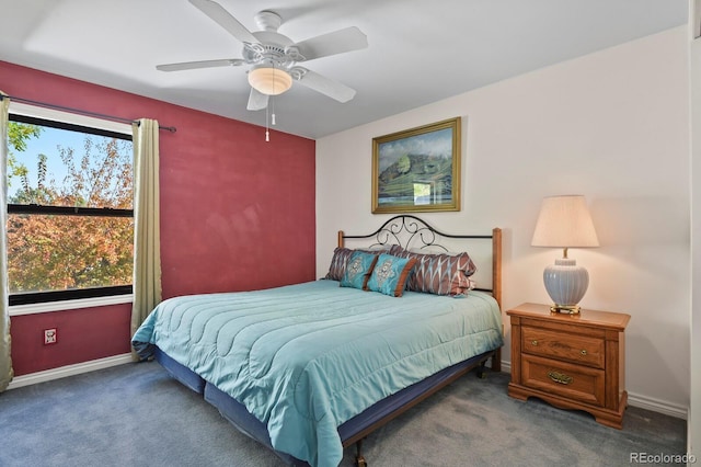 carpeted bedroom featuring multiple windows and ceiling fan