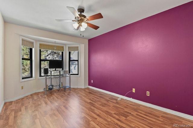 empty room with ceiling fan and wood-type flooring