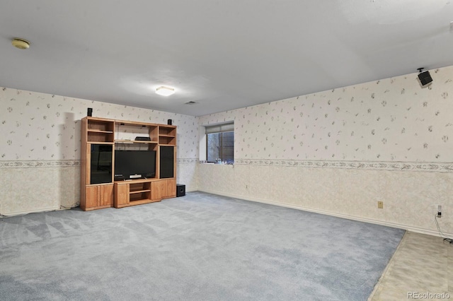 unfurnished living room featuring carpet