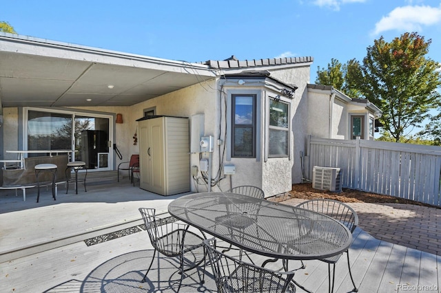 view of patio / terrace featuring a wooden deck and central AC unit