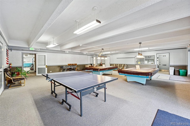 game room with beam ceiling and a textured ceiling