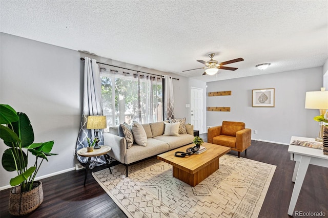 living room featuring ceiling fan, a textured ceiling, and dark hardwood / wood-style floors