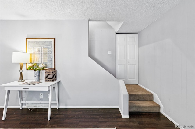 stairway featuring hardwood / wood-style flooring and a textured ceiling