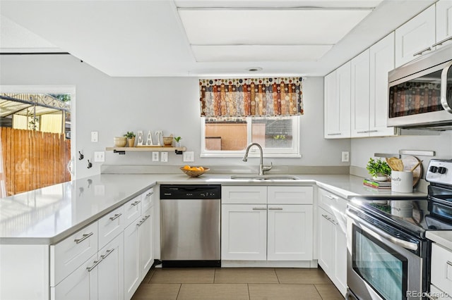 kitchen featuring white cabinetry, appliances with stainless steel finishes, sink, and a healthy amount of sunlight