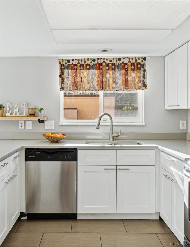 kitchen with dishwasher, sink, white cabinetry, and a healthy amount of sunlight