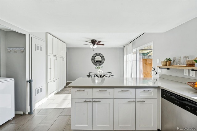 kitchen featuring white cabinets, light wood-type flooring, kitchen peninsula, and stainless steel dishwasher