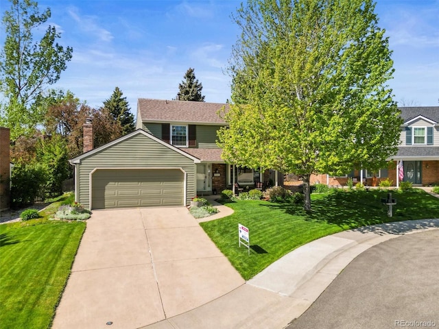 5225 S Everett Ct, Littleton, CO 80123 - view of front of home featuring a front lawn, driveway, an attached garage, and brick siding