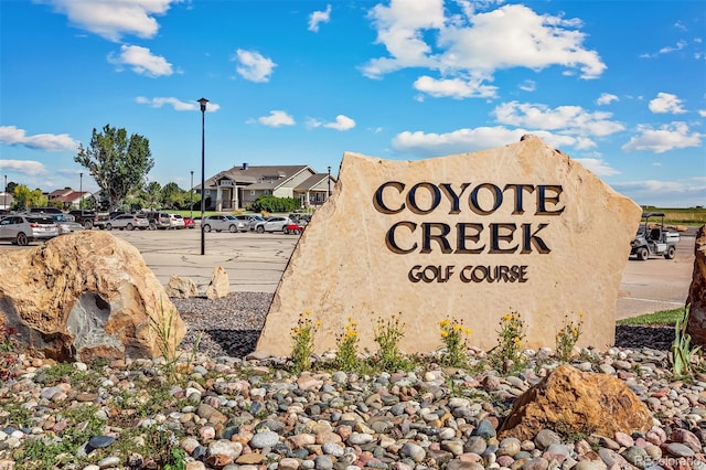 community sign with uncovered parking