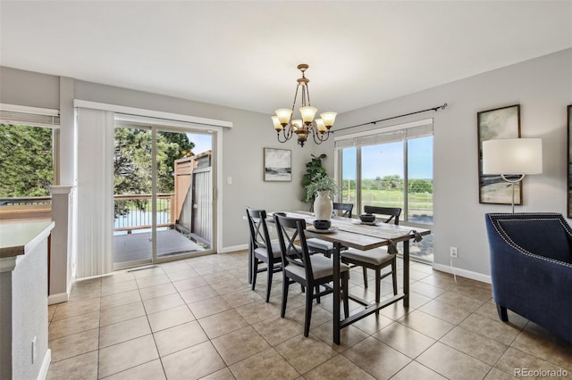 4231 W Ponds Cir, Littleton, CO 80123 - dining room with light tile patterned floors, a chandelier, and plenty of natural light