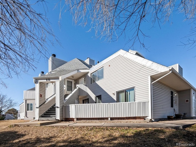 rear view of property featuring a balcony