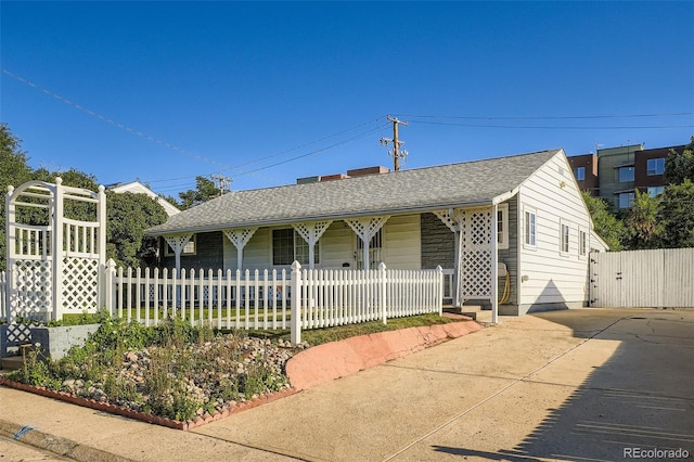 5041 W Nevada Pl, Denver, CO 80219 - ranch-style house with covered porch and a shingled roof