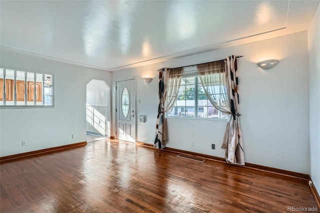 5041 W Nevada Pl, Denver, CO 80219 - empty room with arched walkways and wood finished floors