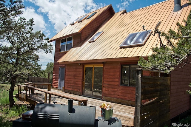 rear view of property featuring a deck