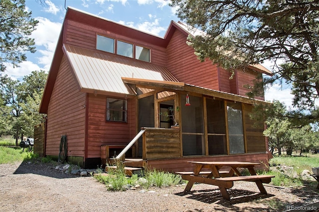 back of house featuring a sunroom