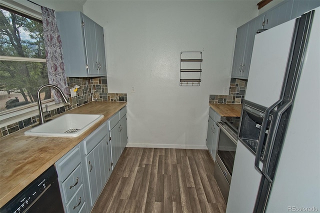 kitchen with gray cabinetry, dishwasher, sink, dark hardwood / wood-style flooring, and white refrigerator with ice dispenser