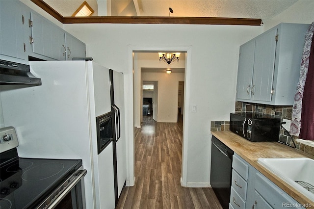 kitchen with an inviting chandelier, black appliances, decorative backsplash, dark hardwood / wood-style floors, and a textured ceiling