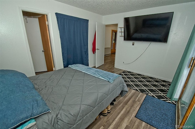 bedroom featuring hardwood / wood-style floors and a textured ceiling