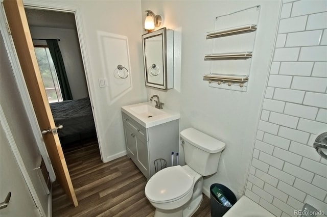 full bathroom with hardwood / wood-style flooring, vanity, toilet, and shower with separate bathtub