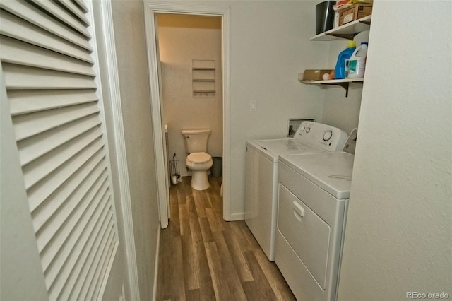 laundry area with separate washer and dryer and dark hardwood / wood-style flooring