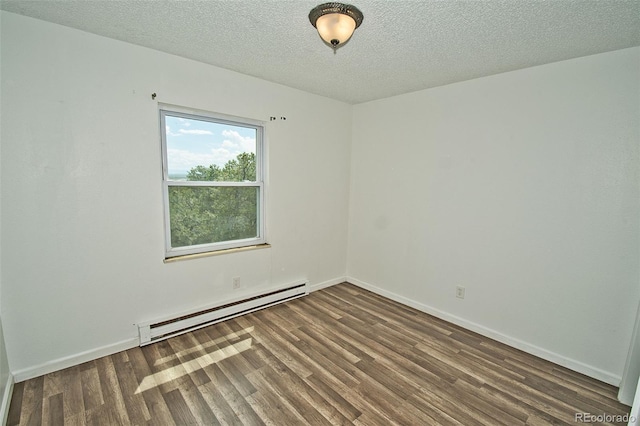 empty room featuring a textured ceiling, baseboard heating, and dark wood-type flooring