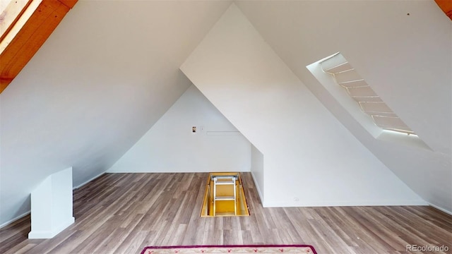 bonus room featuring hardwood / wood-style floors and vaulted ceiling