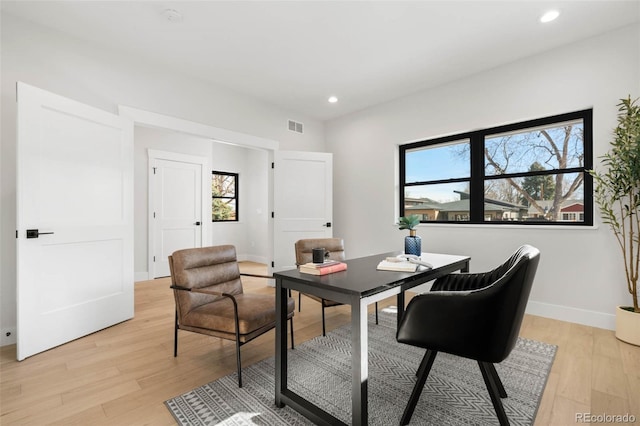 office featuring recessed lighting, light wood-style floors, visible vents, and baseboards