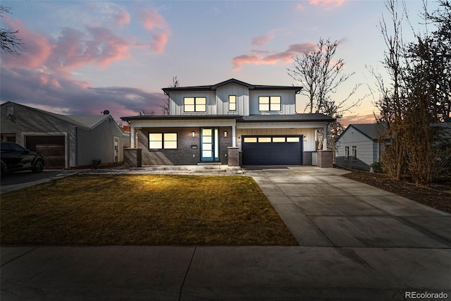 view of front facade featuring brick siding, board and batten siding, a front lawn, concrete driveway, and an attached garage