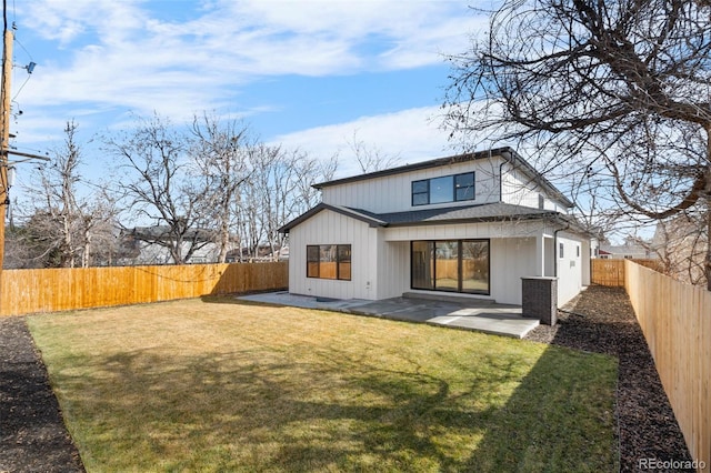 rear view of house with a patio, a yard, and a fenced backyard