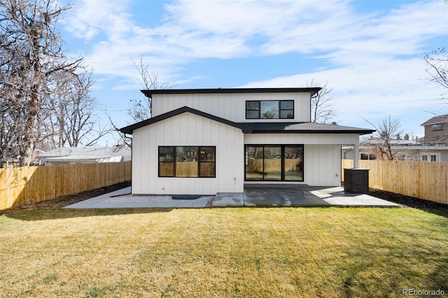 back of house featuring a yard, a fenced backyard, and a patio area