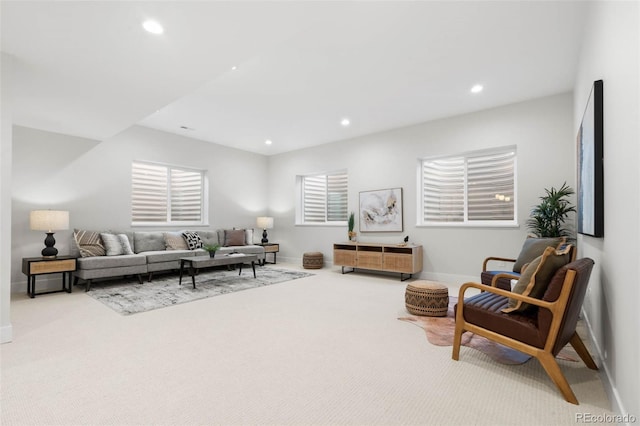 living area featuring recessed lighting, baseboards, and carpet