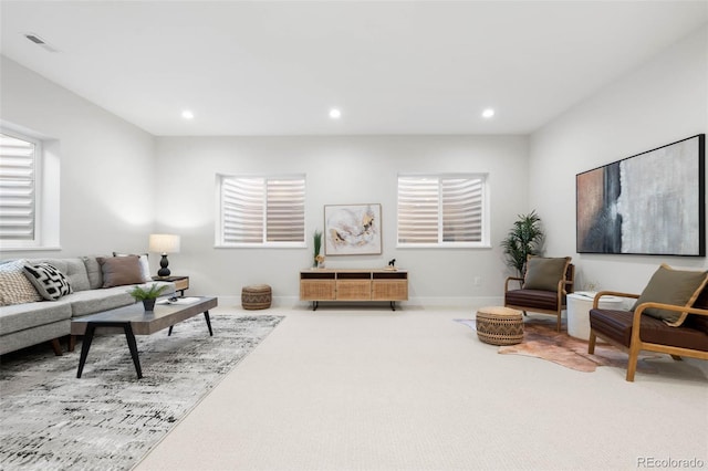 living room with carpet flooring, recessed lighting, visible vents, and baseboards