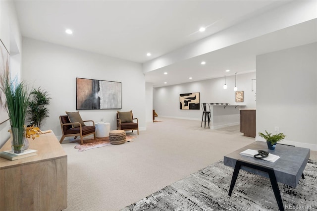 living room featuring recessed lighting, baseboards, and light colored carpet